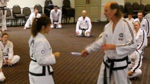 Instructor group training realistic knife defence drills in Taekwon-Do