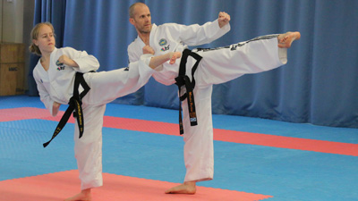 ITF Taekwon-Do practitioners performing TKD patterns in a training session.