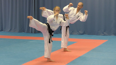 ITF Taekwon-Do practitioners reverse turning kick during a coaching session