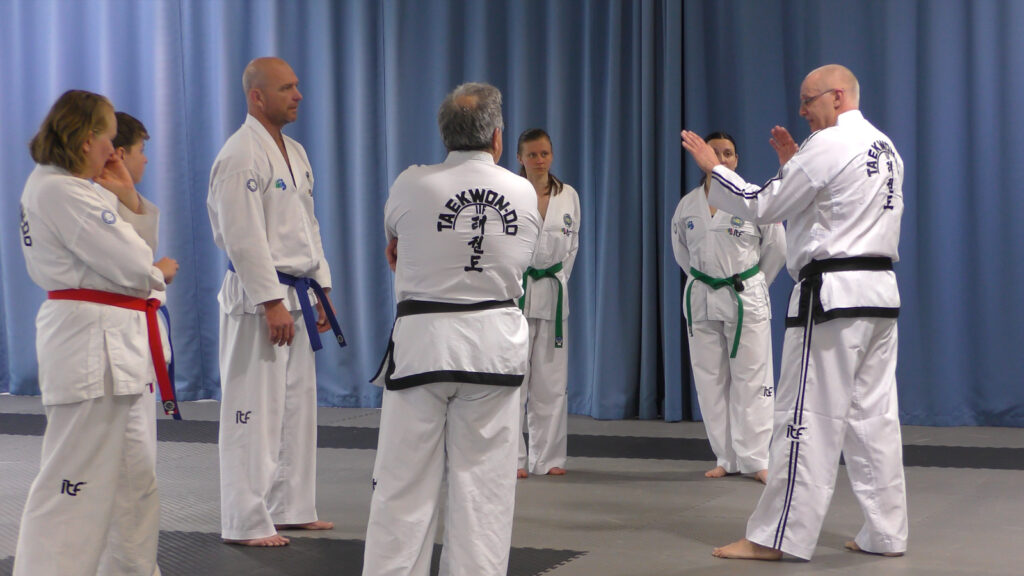 Grand Master Peter Barber teaching a small group Taekwon-Do session, demonstrating traditional movements and practical application.