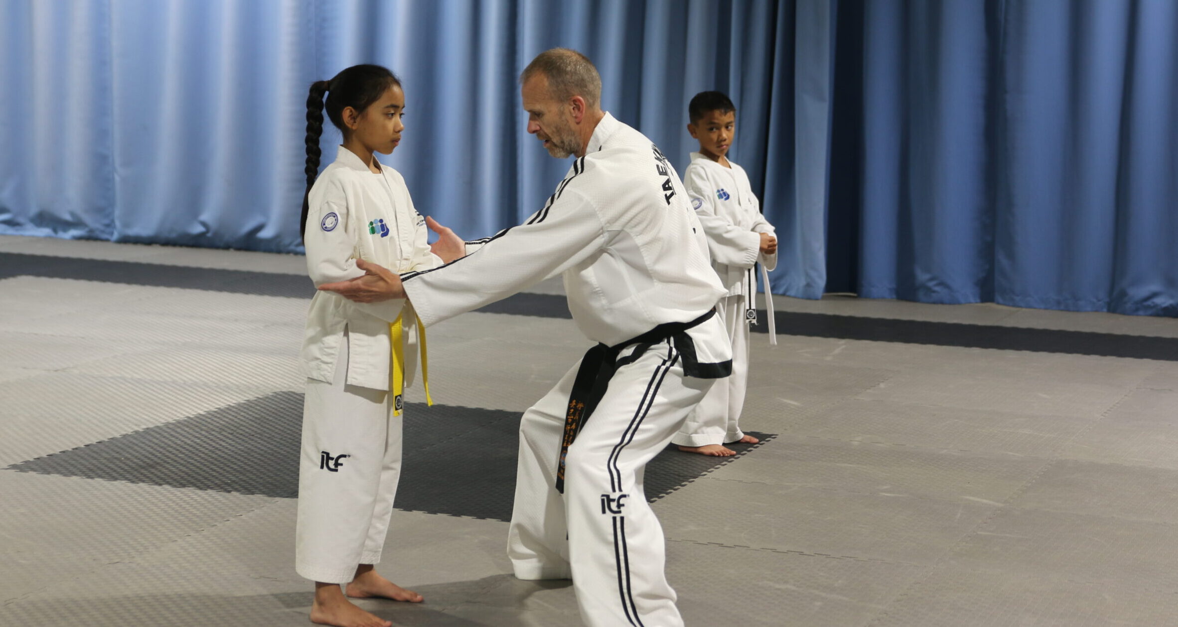 Master Hutton with Alicia and Zeke in a small groups training session